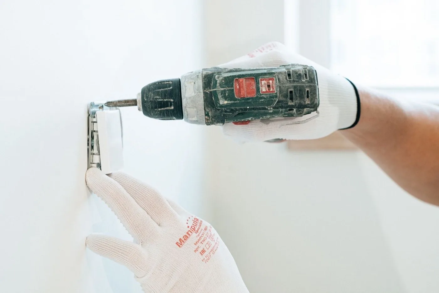 Electrician installing a wall outlet