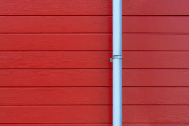 Rain gutter downspout on a house wall