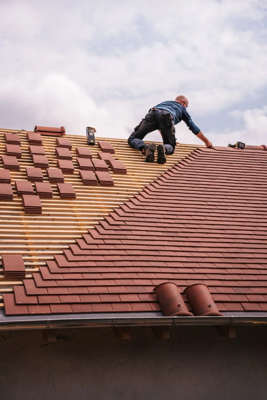 Roofer installing tile roofing
