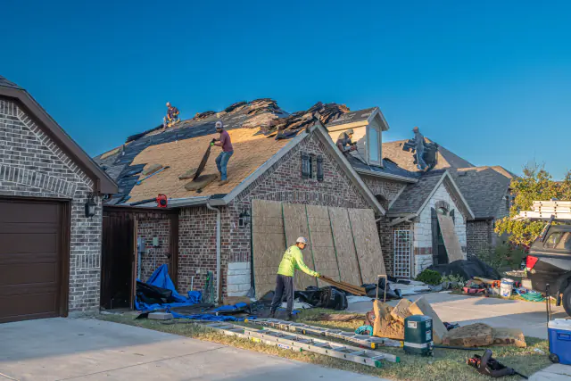 Roof partially stripped for repair on a brick home